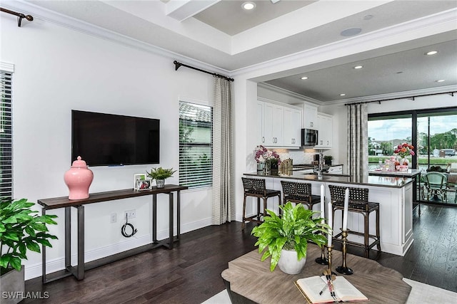 living room with crown molding and dark wood-type flooring