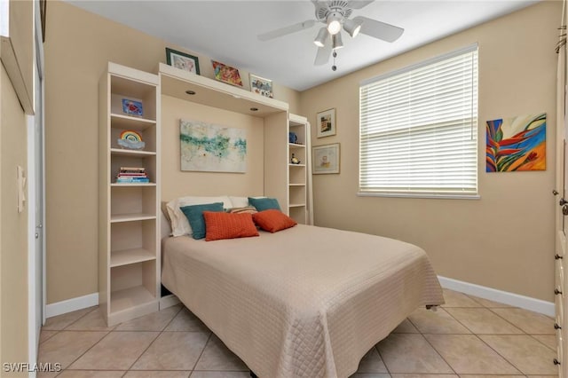 bedroom with ceiling fan and light tile patterned flooring