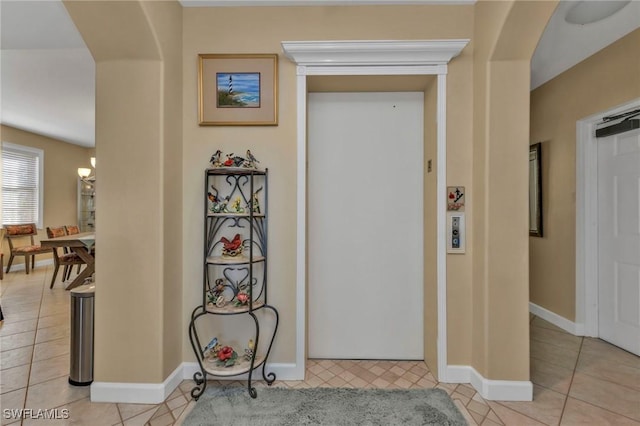 corridor featuring light tile patterned floors and elevator