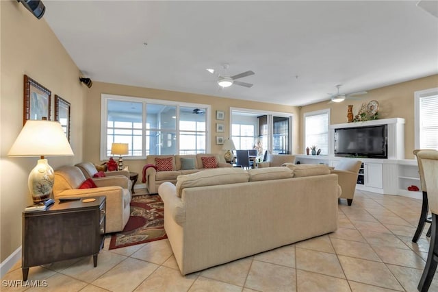 tiled living room with ceiling fan