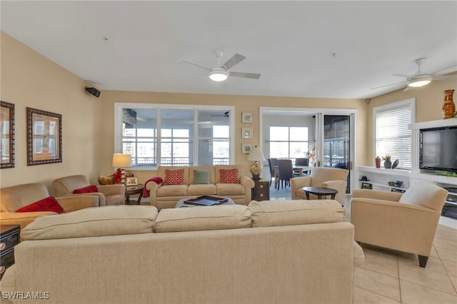 living room featuring plenty of natural light, ceiling fan, and light tile patterned floors