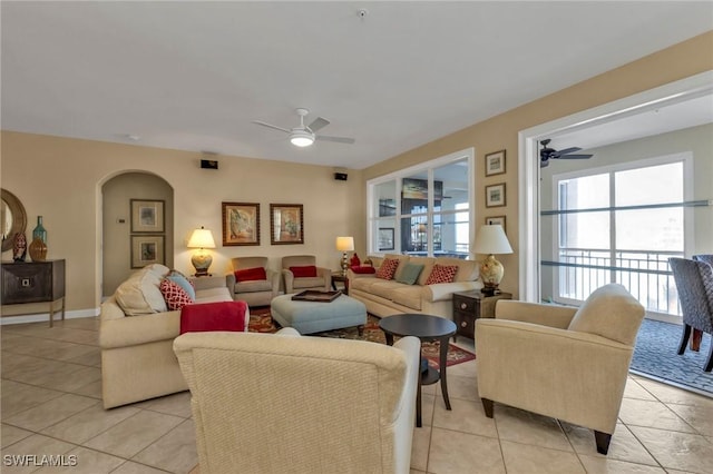 tiled living room with ceiling fan