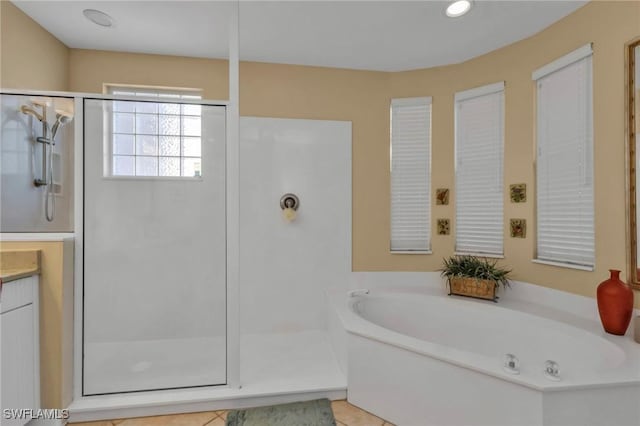 bathroom featuring tile patterned flooring, vanity, and plus walk in shower