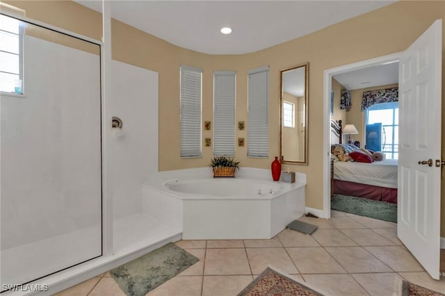 bathroom with separate shower and tub and tile patterned flooring