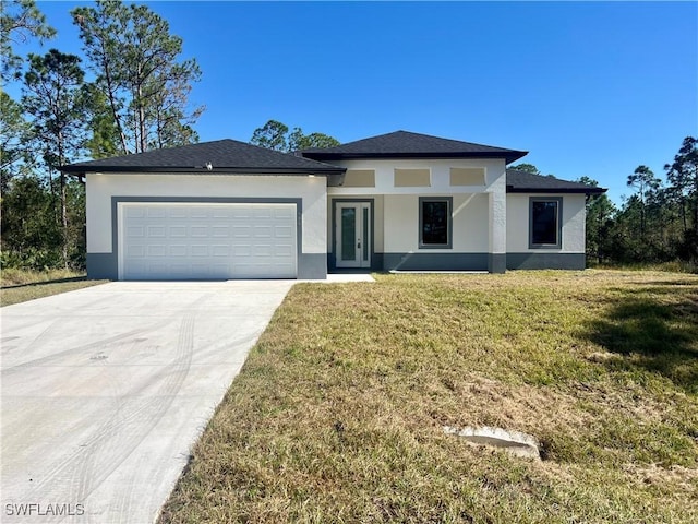 view of front of property featuring a garage and a front lawn