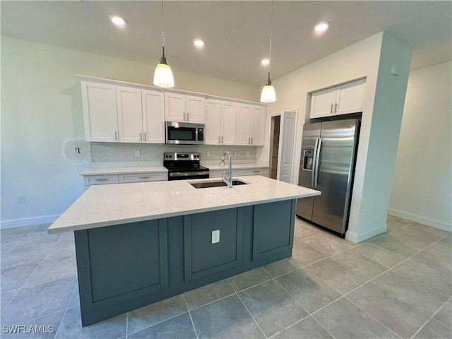 kitchen with white cabinets, pendant lighting, sink, and stainless steel appliances