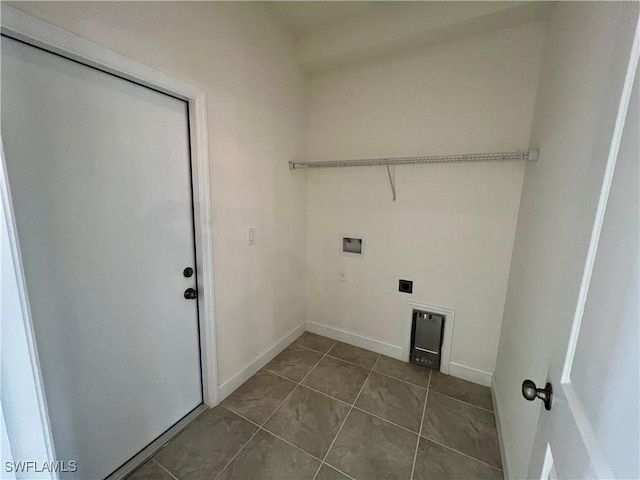 laundry area with dark tile patterned floors, washer hookup, and hookup for an electric dryer