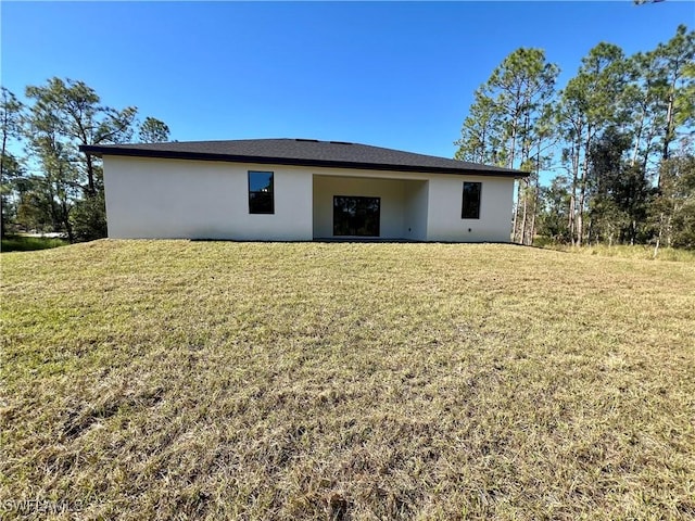 back of house with a yard