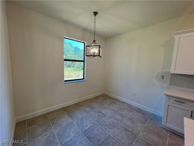 unfurnished dining area with a notable chandelier