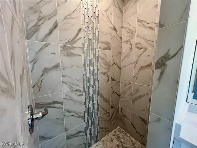 bathroom with tiled shower