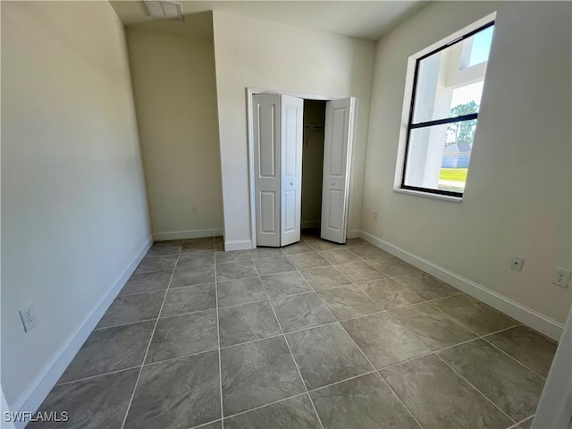 unfurnished bedroom with tile patterned floors