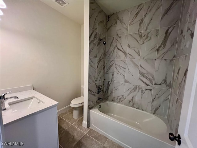 full bathroom with tile patterned flooring, vanity, toilet, and tiled shower / bath