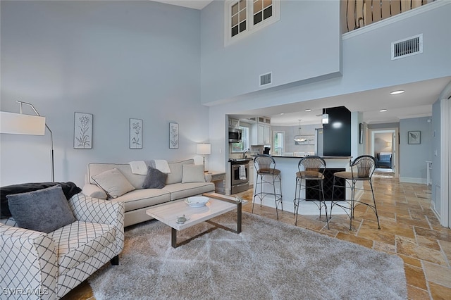 living room featuring a high ceiling