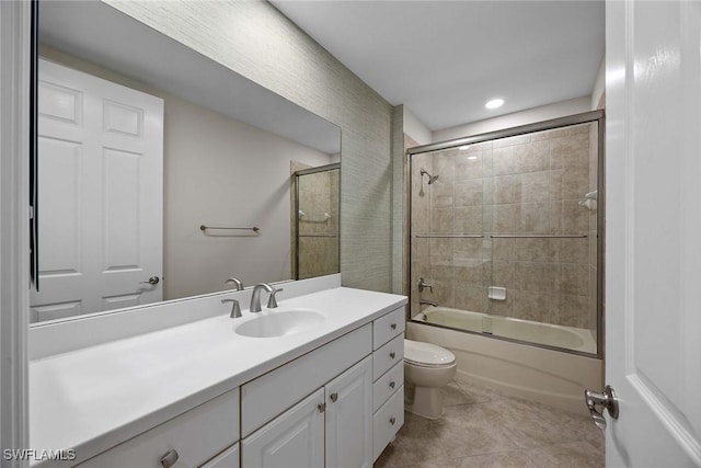 full bathroom featuring toilet, tile patterned flooring, enclosed tub / shower combo, and vanity