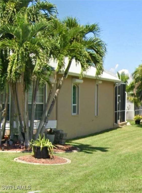 view of property exterior featuring a yard and stucco siding