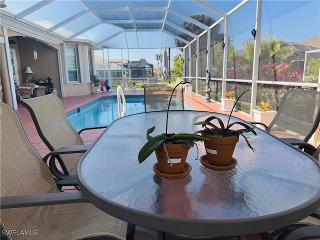 outdoor pool featuring a patio and glass enclosure