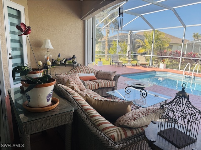 pool featuring glass enclosure, outdoor lounge area, and a patio