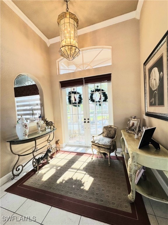 entryway featuring ornamental molding, a healthy amount of sunlight, baseboards, and tile patterned floors