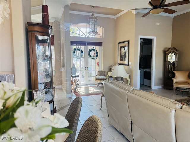 living area with light tile patterned floors, baseboards, and crown molding