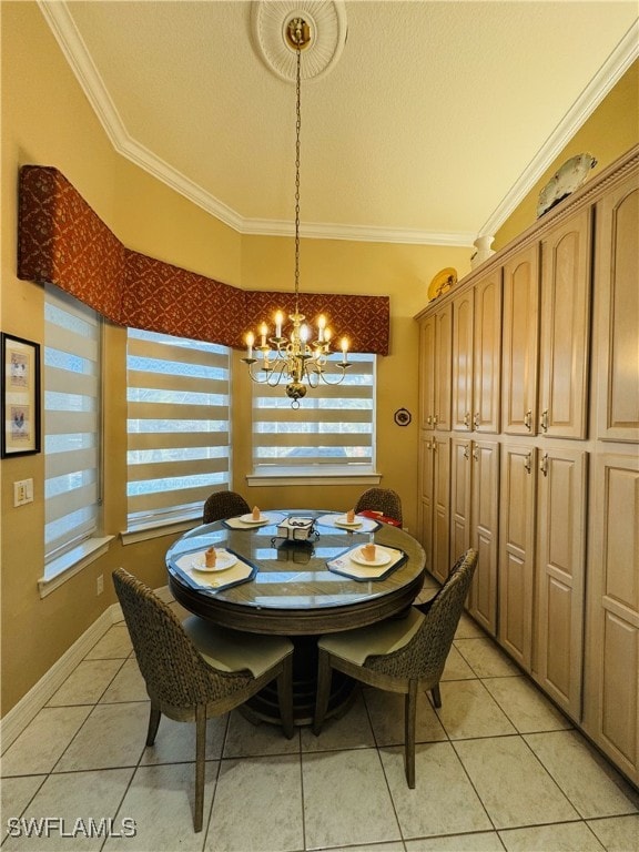 dining space with light tile patterned floors, ornamental molding, a textured ceiling, a chandelier, and baseboards