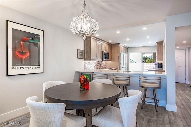 dining area with dark hardwood / wood-style floors and a chandelier