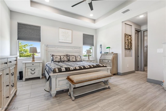 bedroom featuring a tray ceiling and ceiling fan