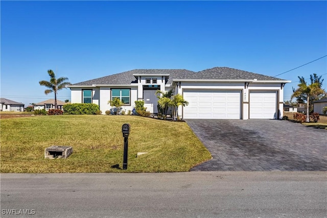 view of front of house featuring a front yard and a garage