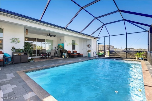 view of swimming pool with a patio area, ceiling fan, and a lanai