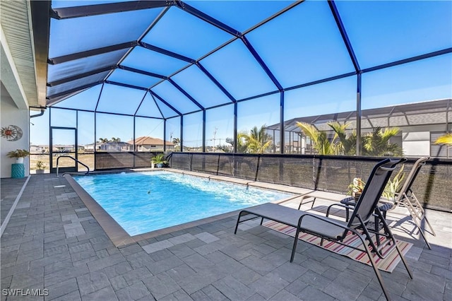 view of pool with a patio area and a lanai