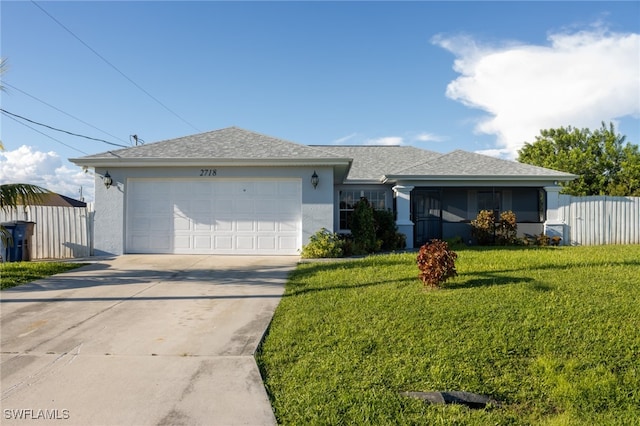 ranch-style home with a garage and a front lawn