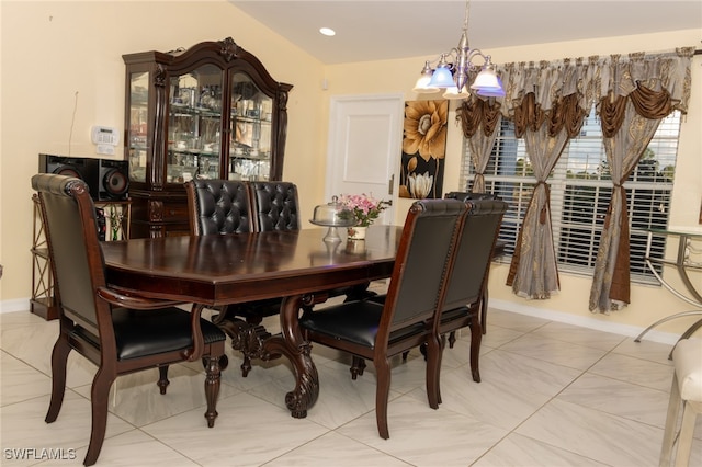 dining space featuring light tile patterned flooring and an inviting chandelier