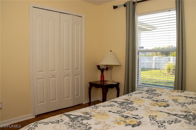 bedroom featuring dark hardwood / wood-style flooring and a closet