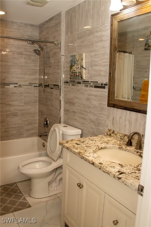 full bathroom with shower / bath combo, vanity, and toilet