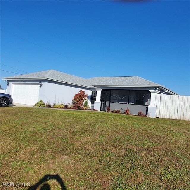 single story home featuring a front yard and a garage