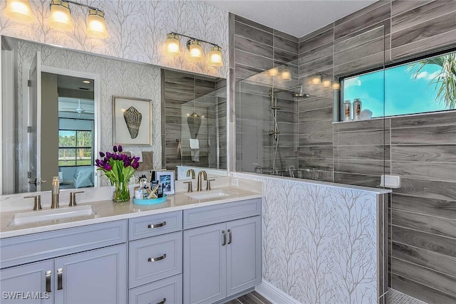 bathroom featuring a tile shower and vanity