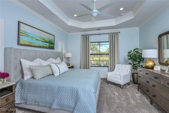 bedroom with carpet, ceiling fan, a raised ceiling, and ornamental molding