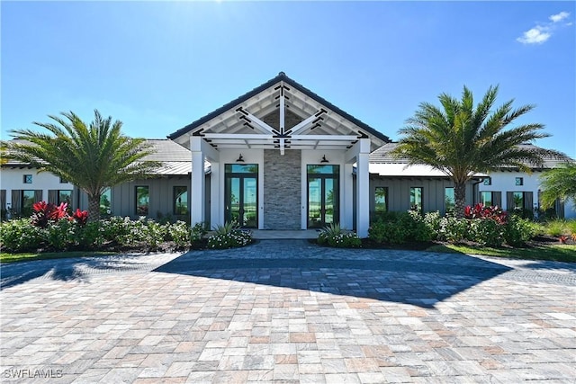 4096 Pegasus Way, Naples, FL 34120 - view of front of house featuring board and batten siding and french doors