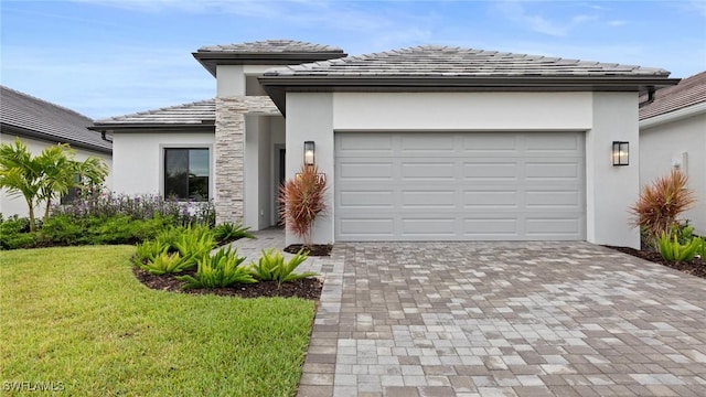 4096 Pegasus Way, Naples, FL 34120 - prairie-style house with stucco siding, decorative driveway, a front lawn, an attached garage, and a tiled roof