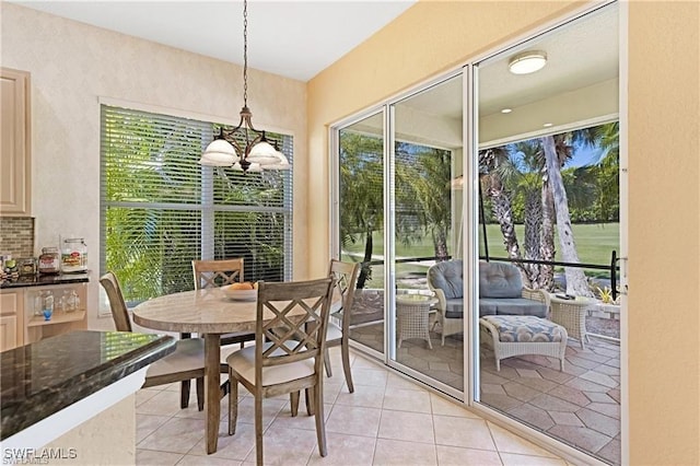 tiled dining area featuring a chandelier