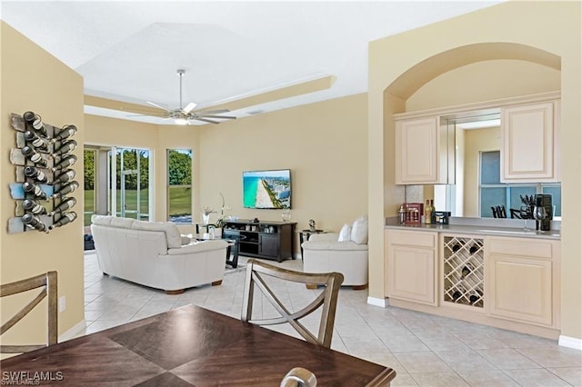 tiled living room featuring ceiling fan