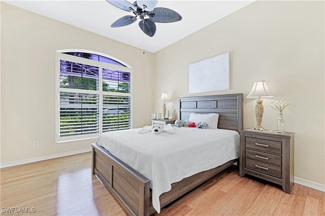 bedroom with ceiling fan and light hardwood / wood-style floors