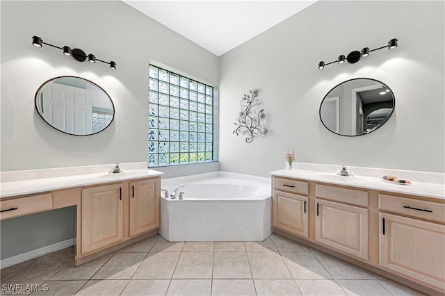 bathroom featuring tile patterned flooring, a washtub, and a wealth of natural light