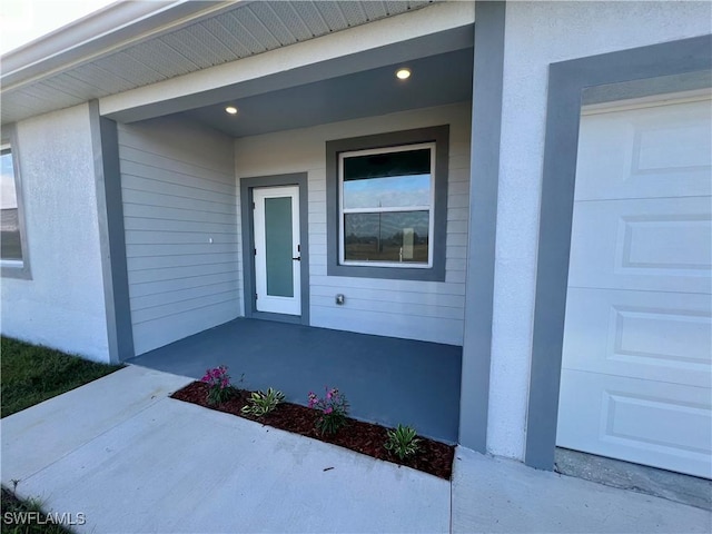 view of exterior entry with a garage