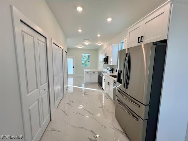 kitchen featuring appliances with stainless steel finishes and white cabinetry