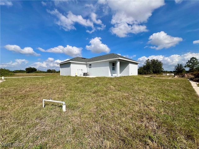 view of side of property with a yard