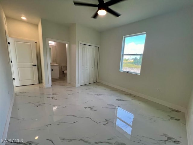 unfurnished bedroom with connected bathroom, ceiling fan, and a closet