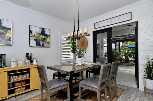 dining room featuring plenty of natural light and ornamental molding