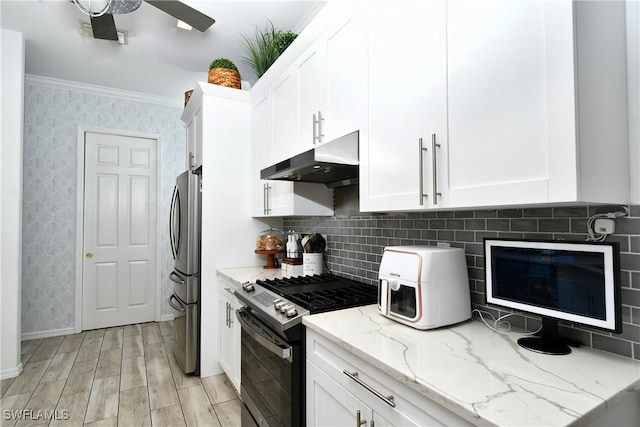 kitchen featuring light stone counters, ornamental molding, stainless steel appliances, light hardwood / wood-style floors, and white cabinets