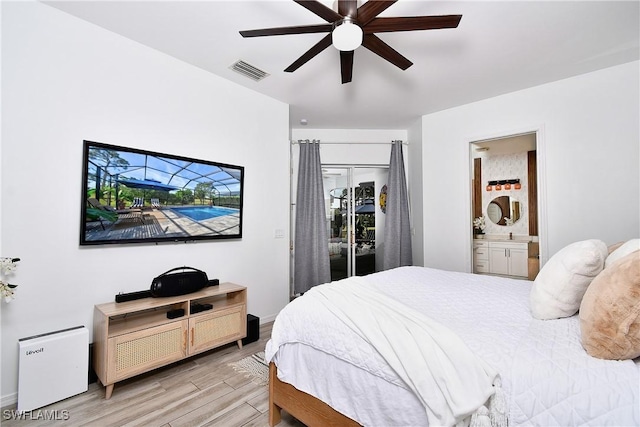 bedroom featuring light wood-type flooring, connected bathroom, and ceiling fan