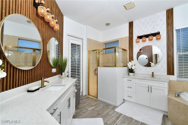 bathroom featuring vanity and separate shower and tub